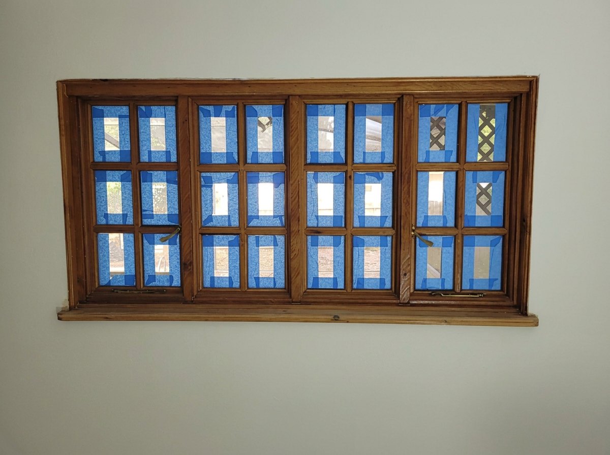 Window trim prepped and taped for painting — 124 Tropic Blvd E, Largo, FL