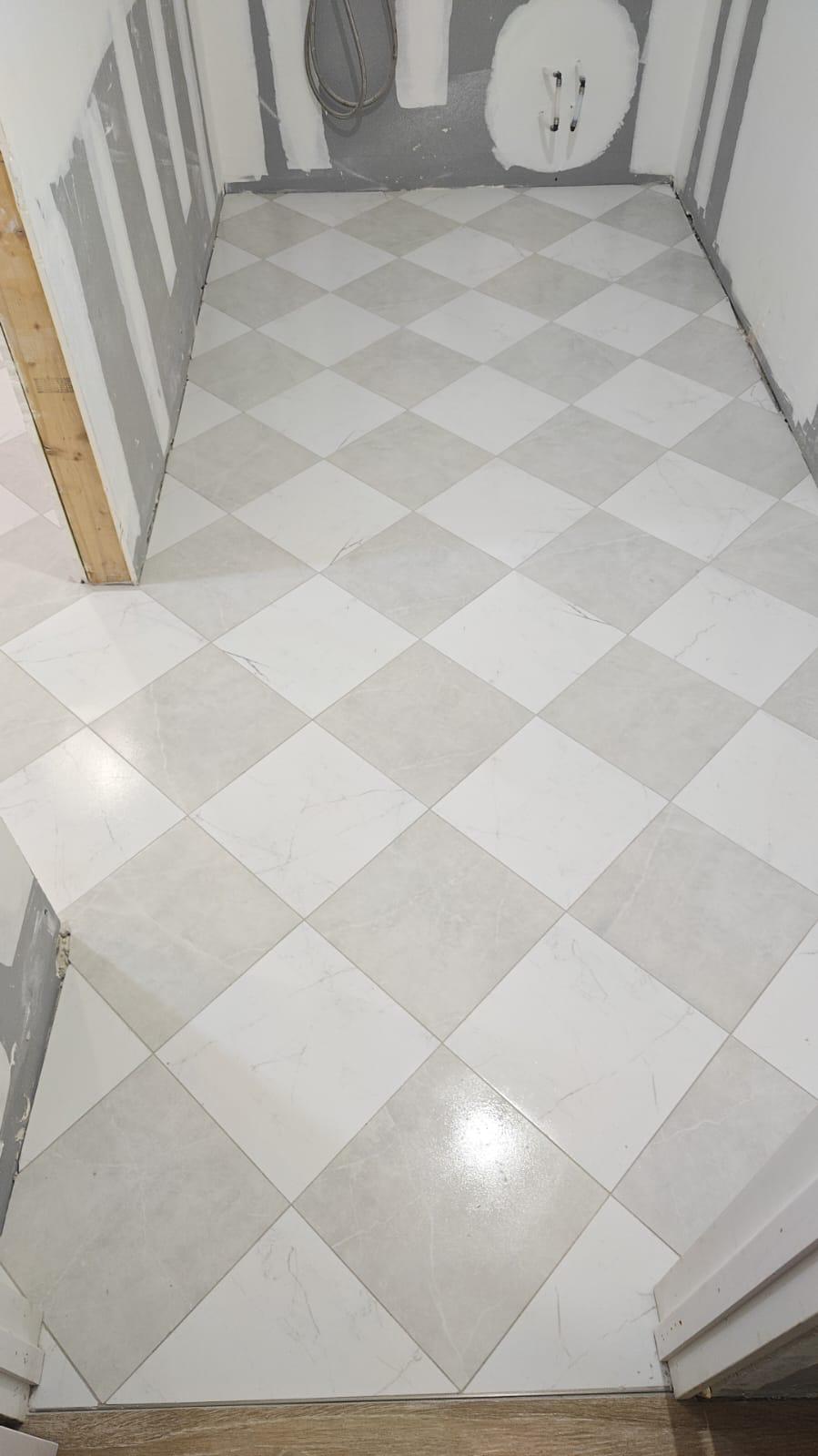 Checkered white and grey tile floor installed on the diagonal