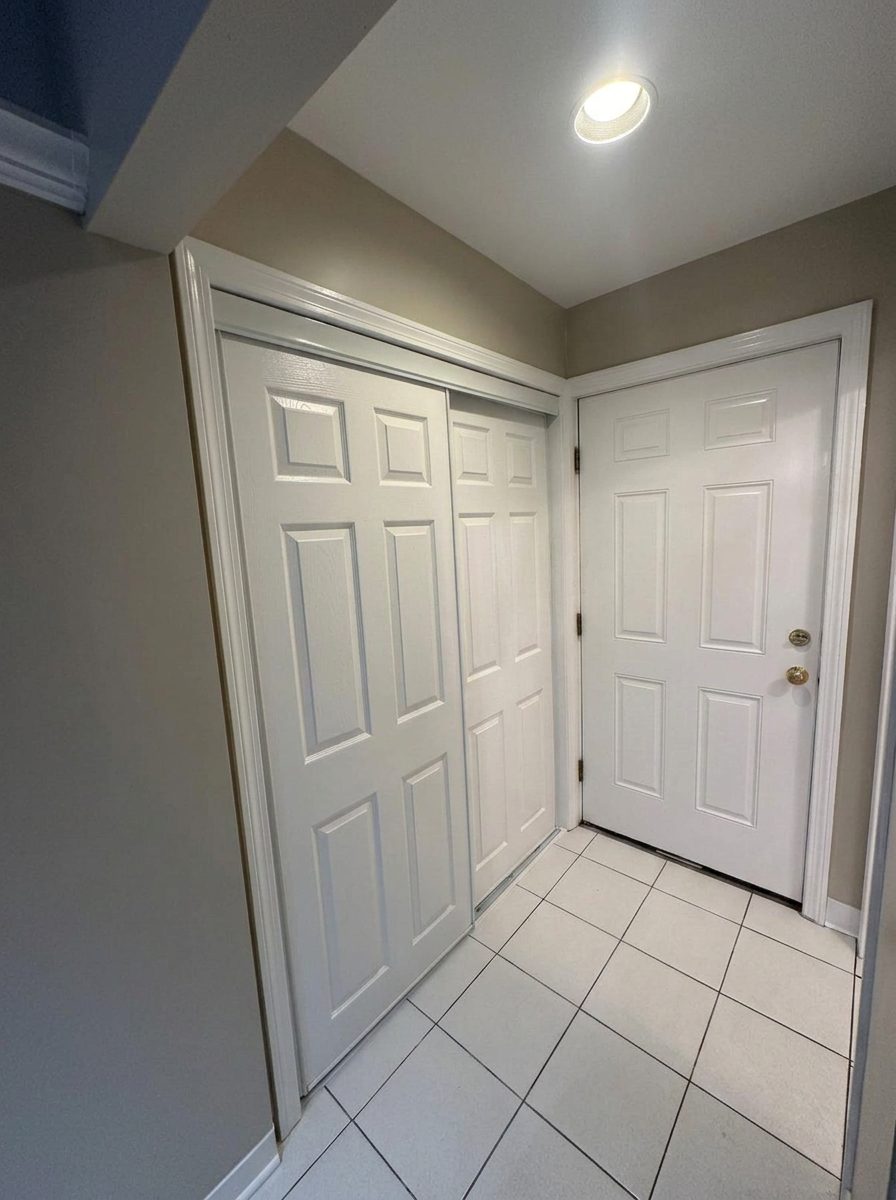 Finished white closet and entry doors with painted trim
