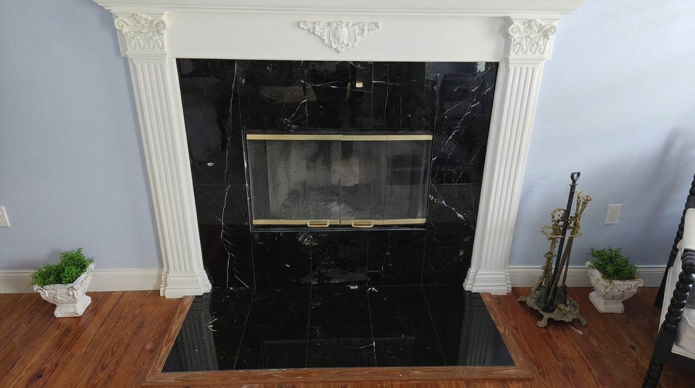 Black marble fireplace surround and hearth being installed