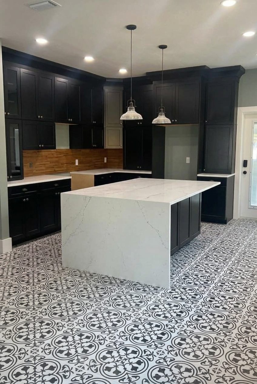 Kitchen remodel with black cabinets, island and patterned tile floor