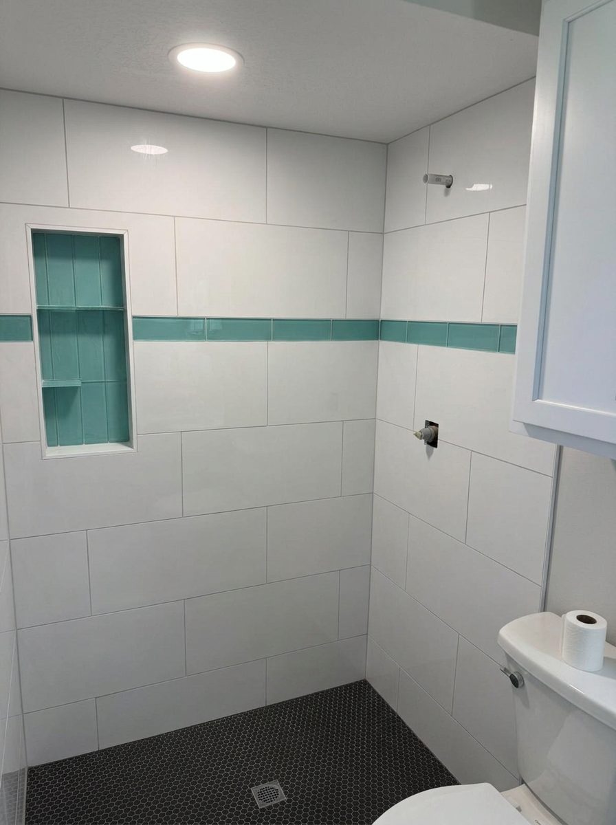 White tiled shower with green glass accent stripe — same project as the marble feature wall